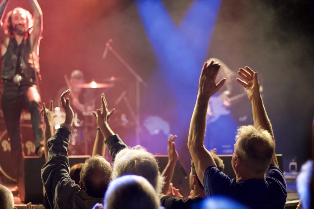 Audience with hands raised during Deeper Purple live performance at The Brook Southampton