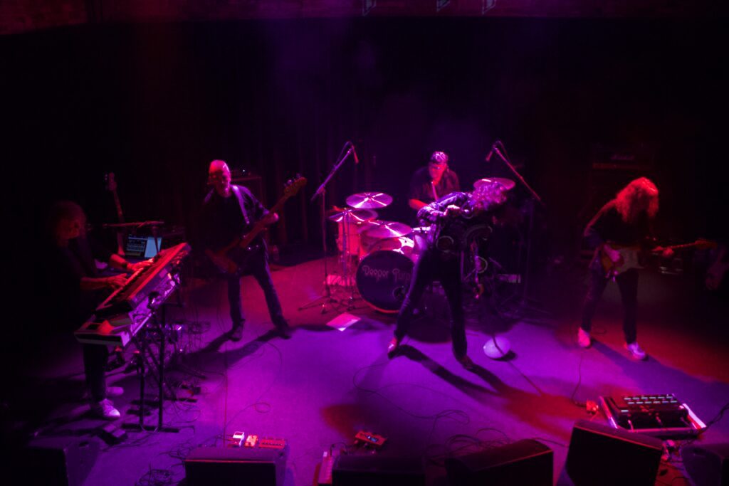 Deeper Purple full band performing live on stage at The Brook Southampton under red lighting