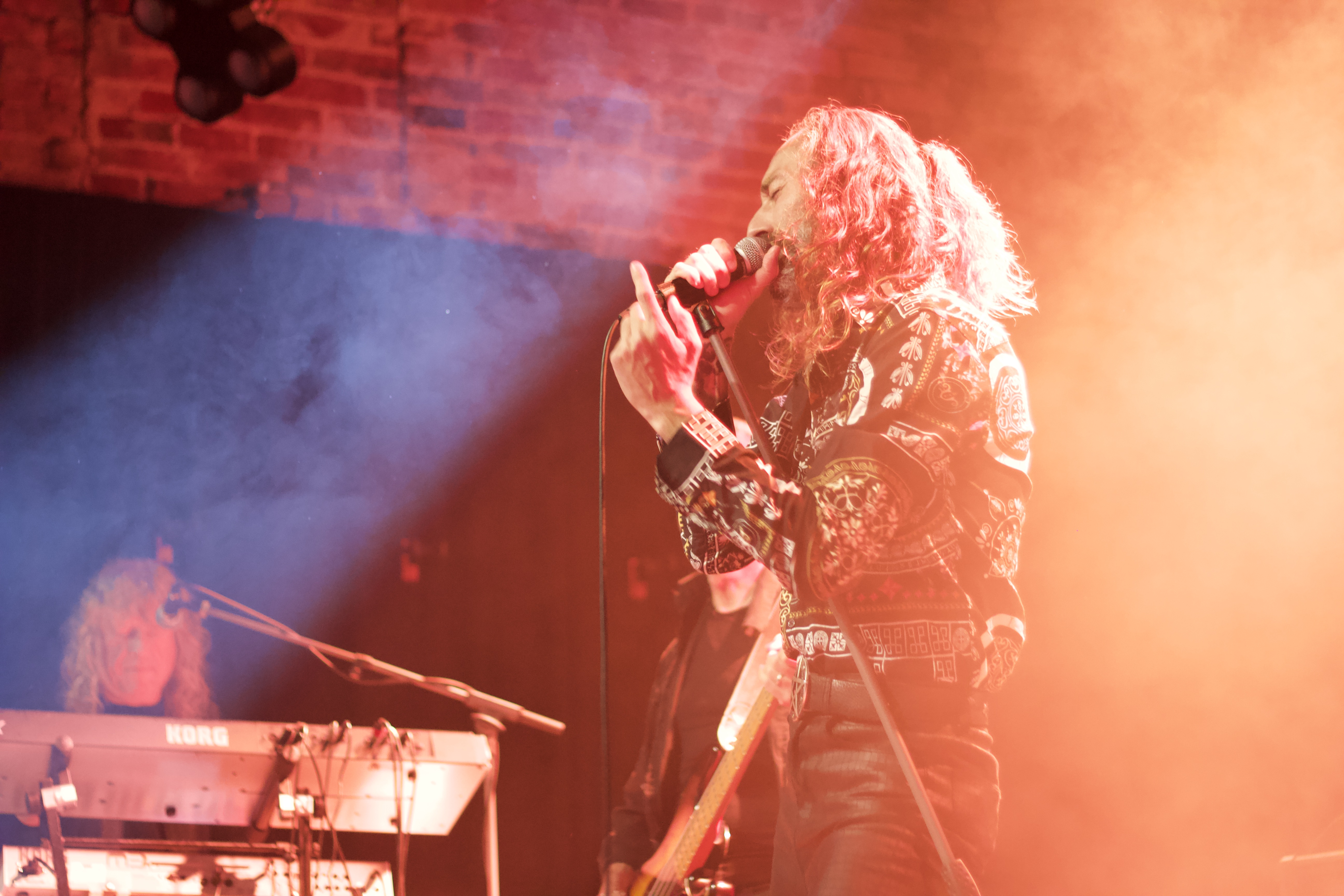 Lead singer of Deeper Purple performing under warm stage lighting at The Brook Southampton
