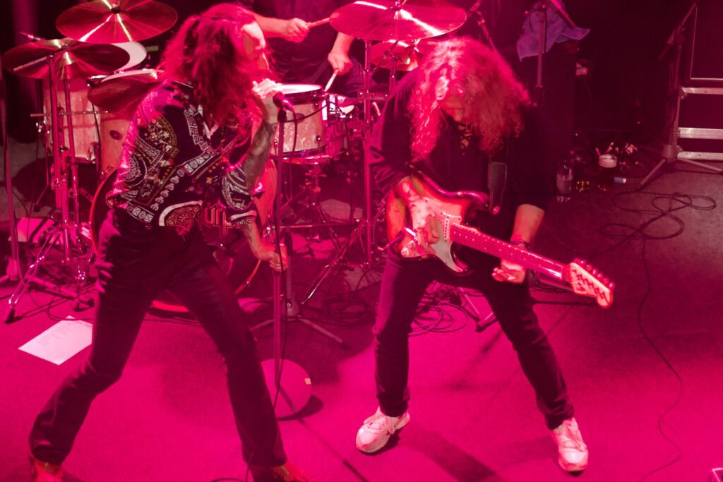 Lead singer and guitarist locked in call-and-response during Deeper Purple live performance at The Brook Southampton