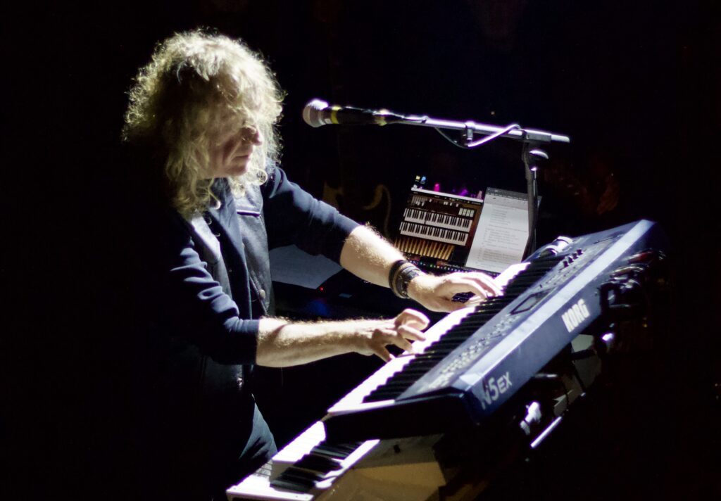 Keyboard player performing live on Korg keyboard during Deeper Purple show at The Brook Southampton