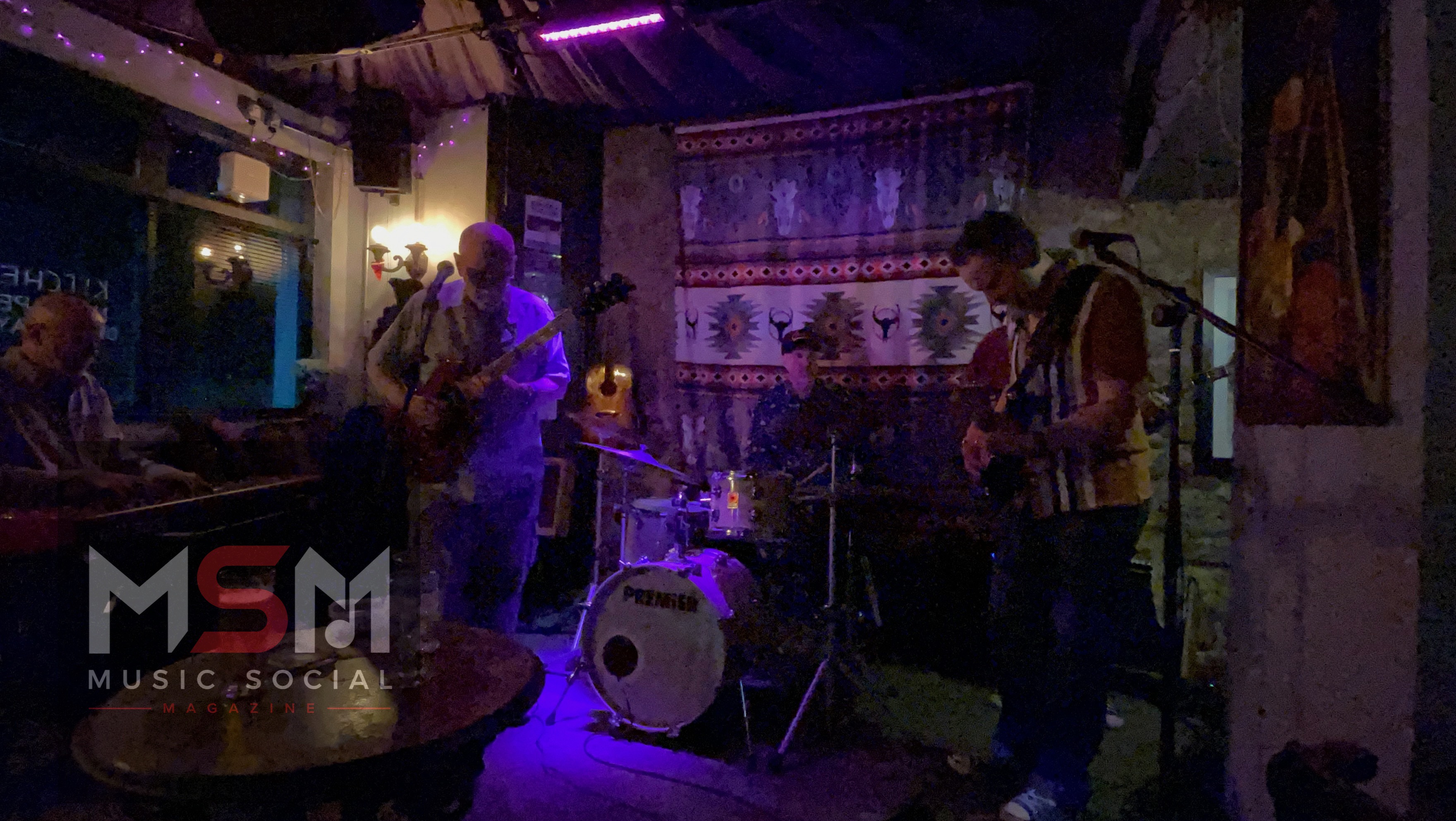 Atmospheric wide shot of The Blues Social live music night inside The Platform Tavern, Southampton, featuring the band performing beneath purple stage lighting inside the historic dockside venue.