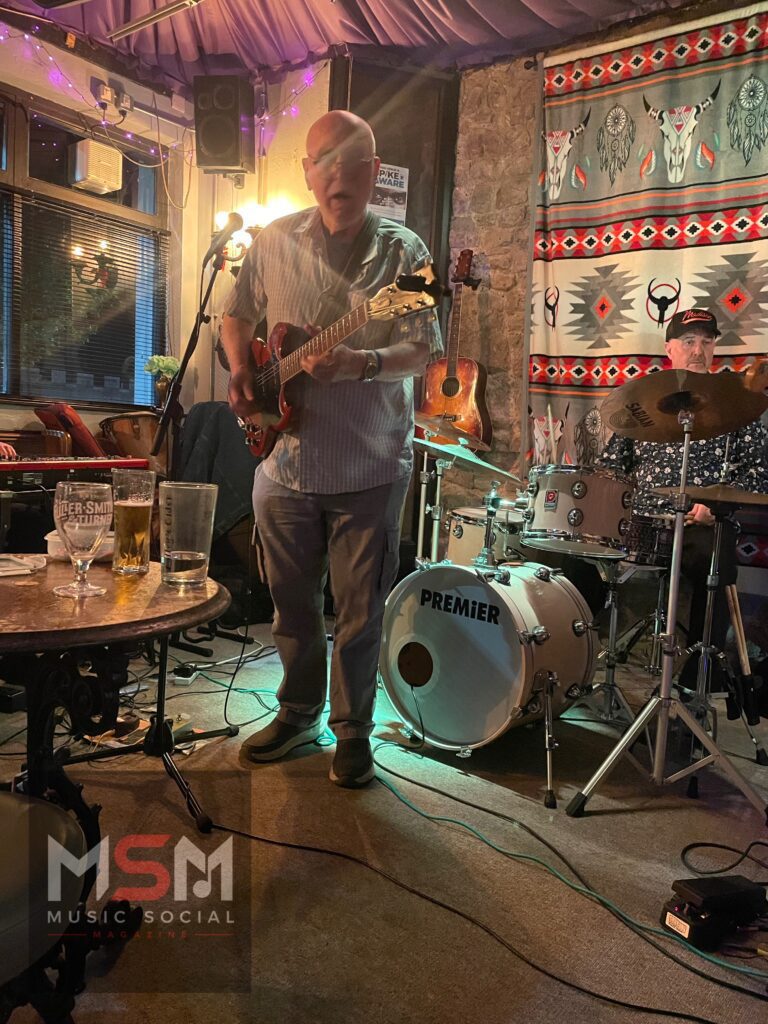 Pete Harris performing live on guitar and vocals during The Blues Social at The Platform Tavern in Southampton, accompanied by Mike Jessop on drums inside the historic dockside venue.