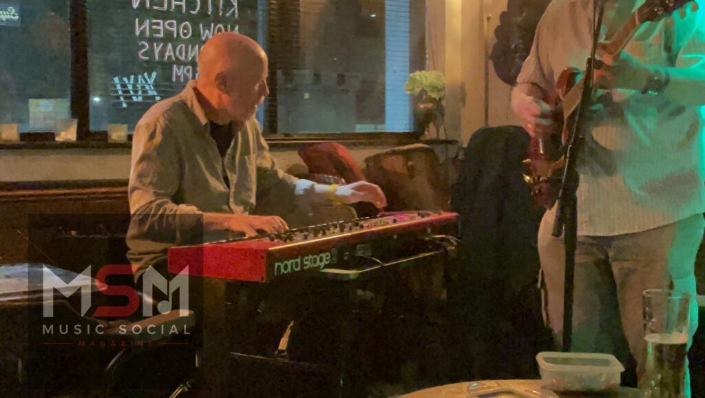 Keyboard player Bill performing at The Blues Social inside The Platform Tavern, Southampton, playing a red Nord Stage keyboard during an intimate live blues session.