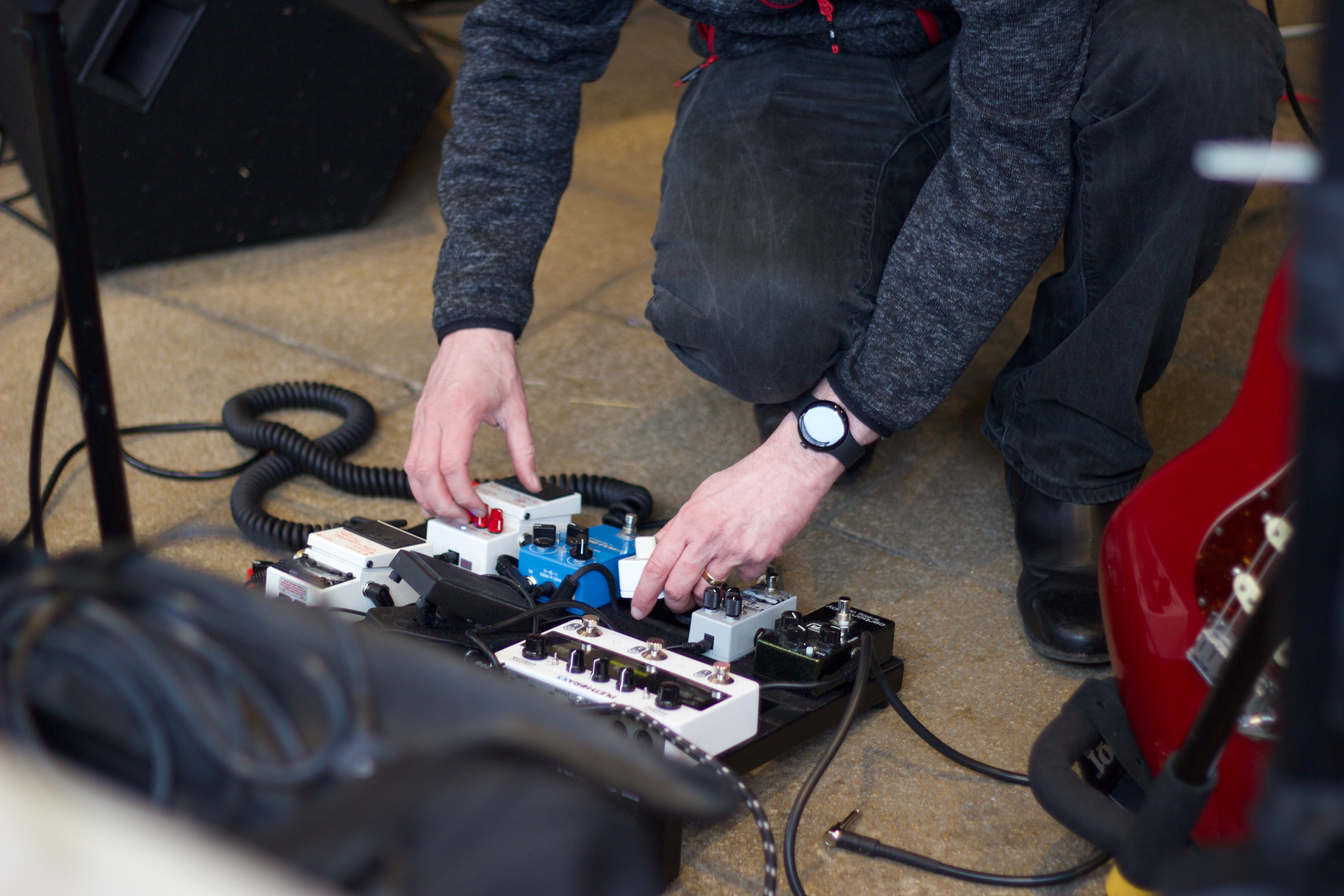 Guitarist adjusting pedal board during Supersonic Spirit soundcheck at Brew Fest in Botley.