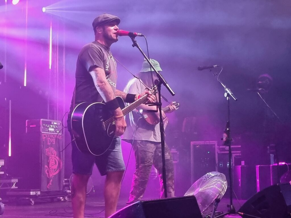 A musician performs on stage under purple lighting at Wickham Festival. Image supplied courtesy of Wickham Festival.
